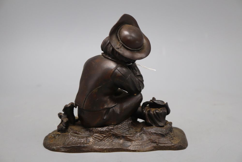 A mid 19th century bronze of a boy seated in a grapevine with a hand sickle, height 14cm